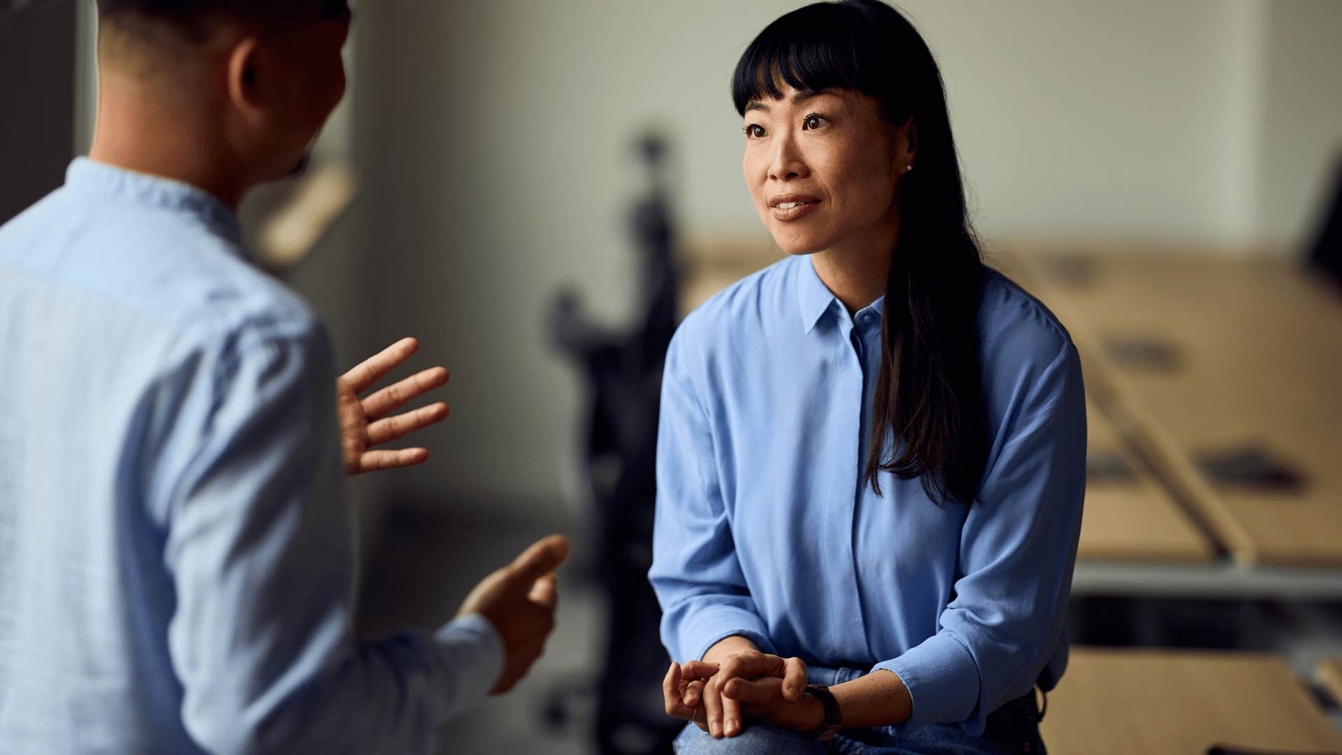 Woman noticing body language and energy at work.