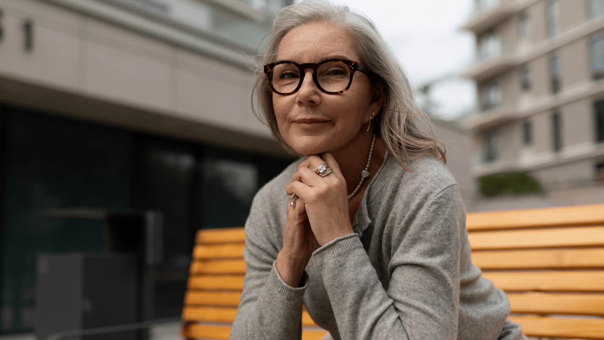 Woman who knows when to be quiet sitting alone outside.