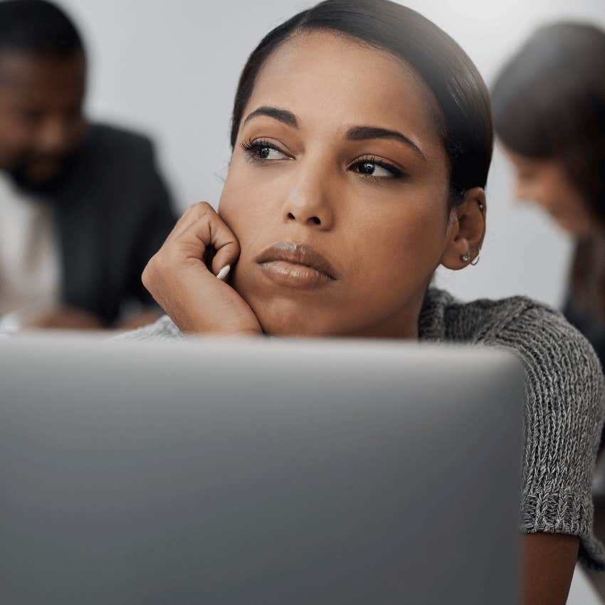 Woman daydreaming or zoning out at work.