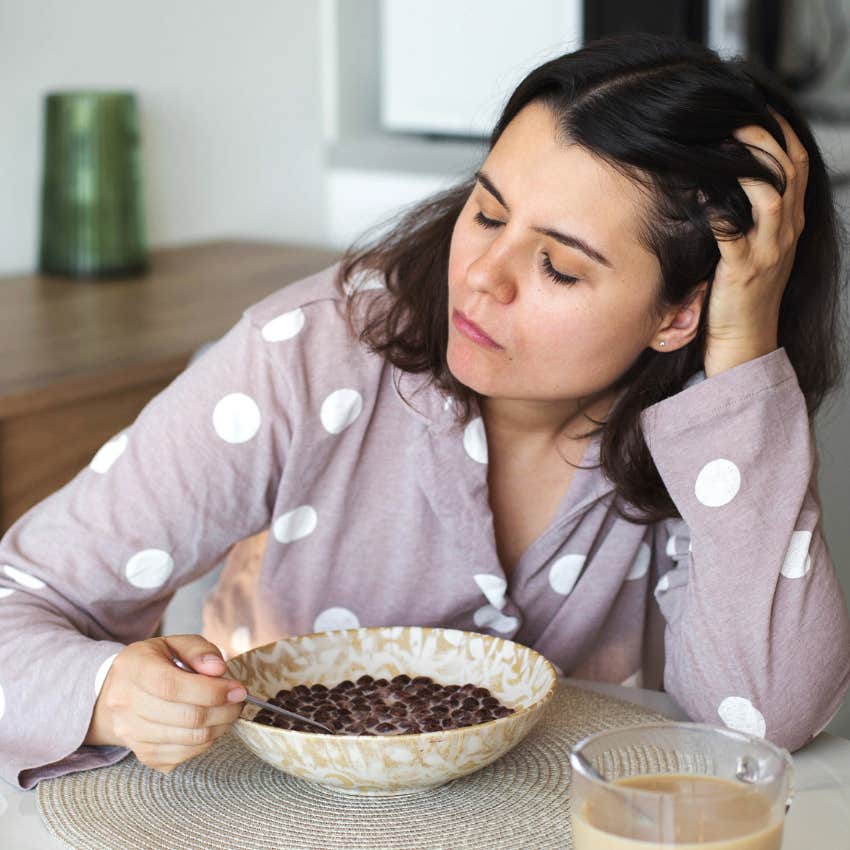 tired woman eating breakfast skipping intentional movement