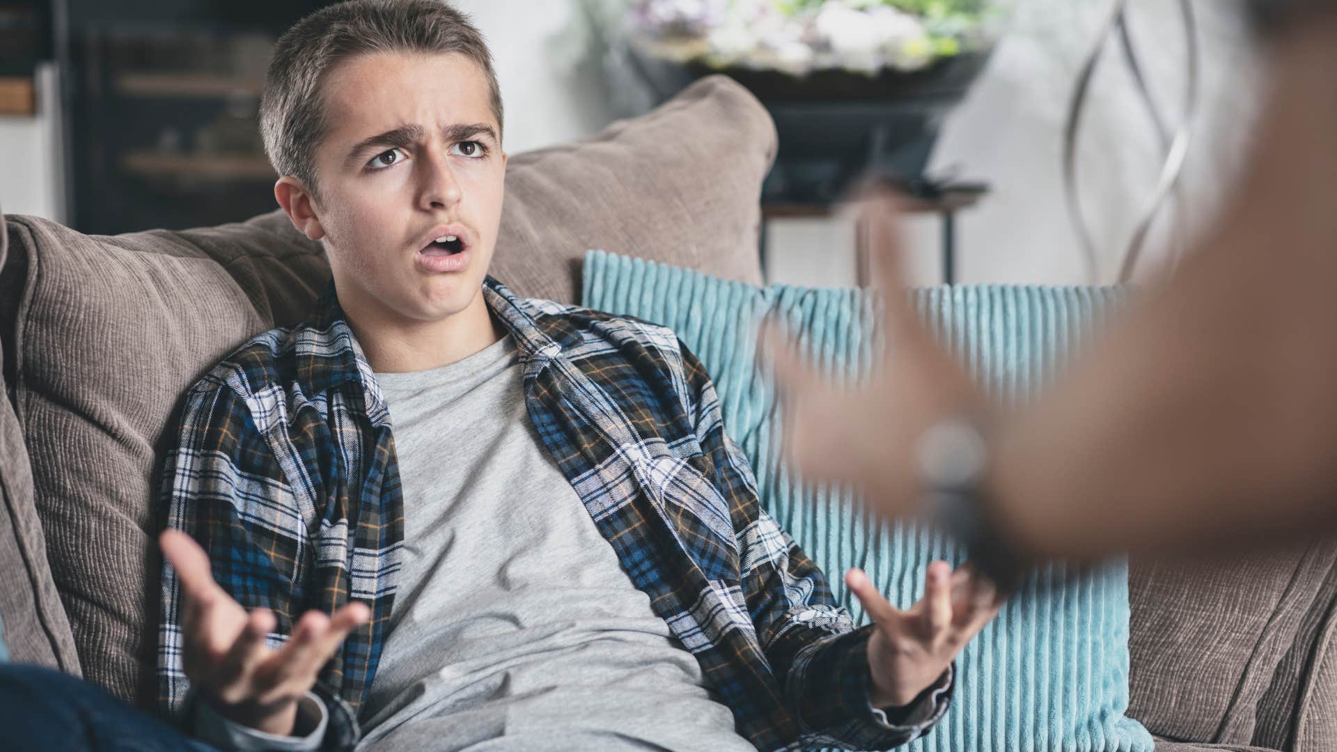 young man receiving tough love from his parent