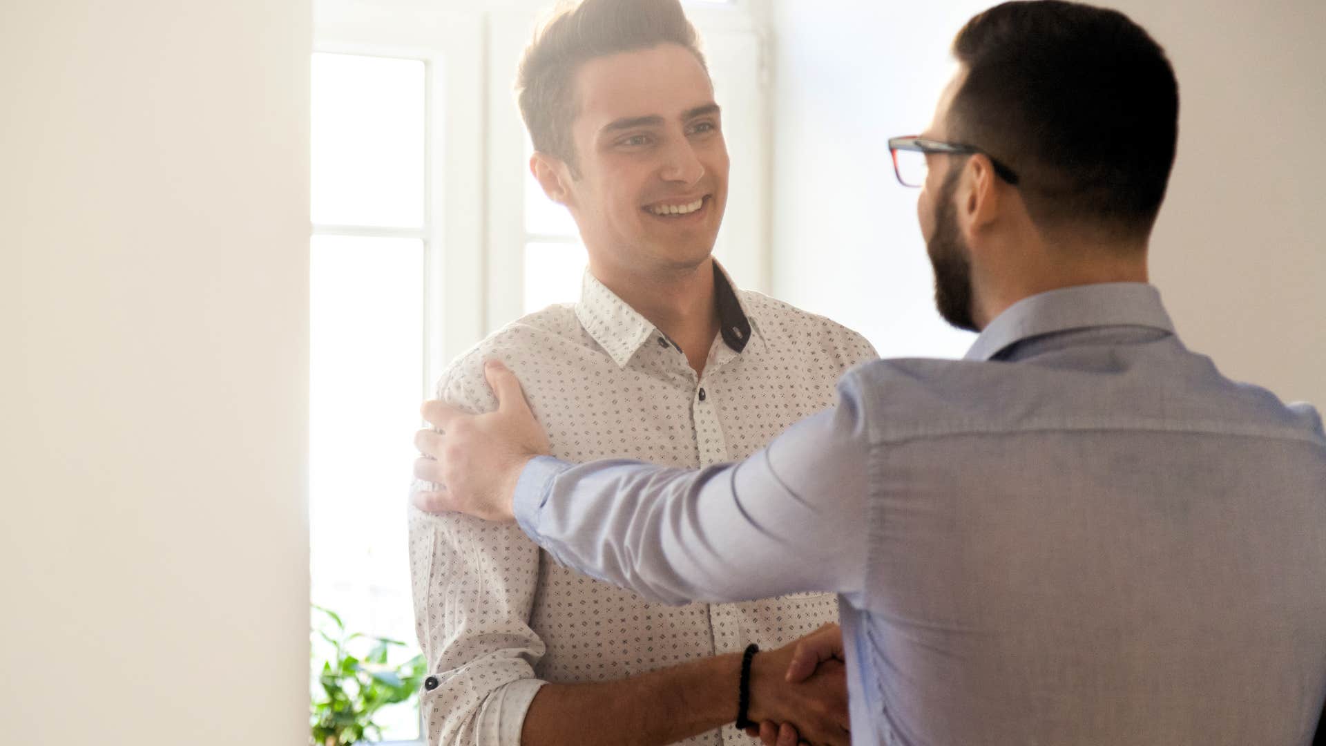 oldest son who's used to needing praise shaking hands at work