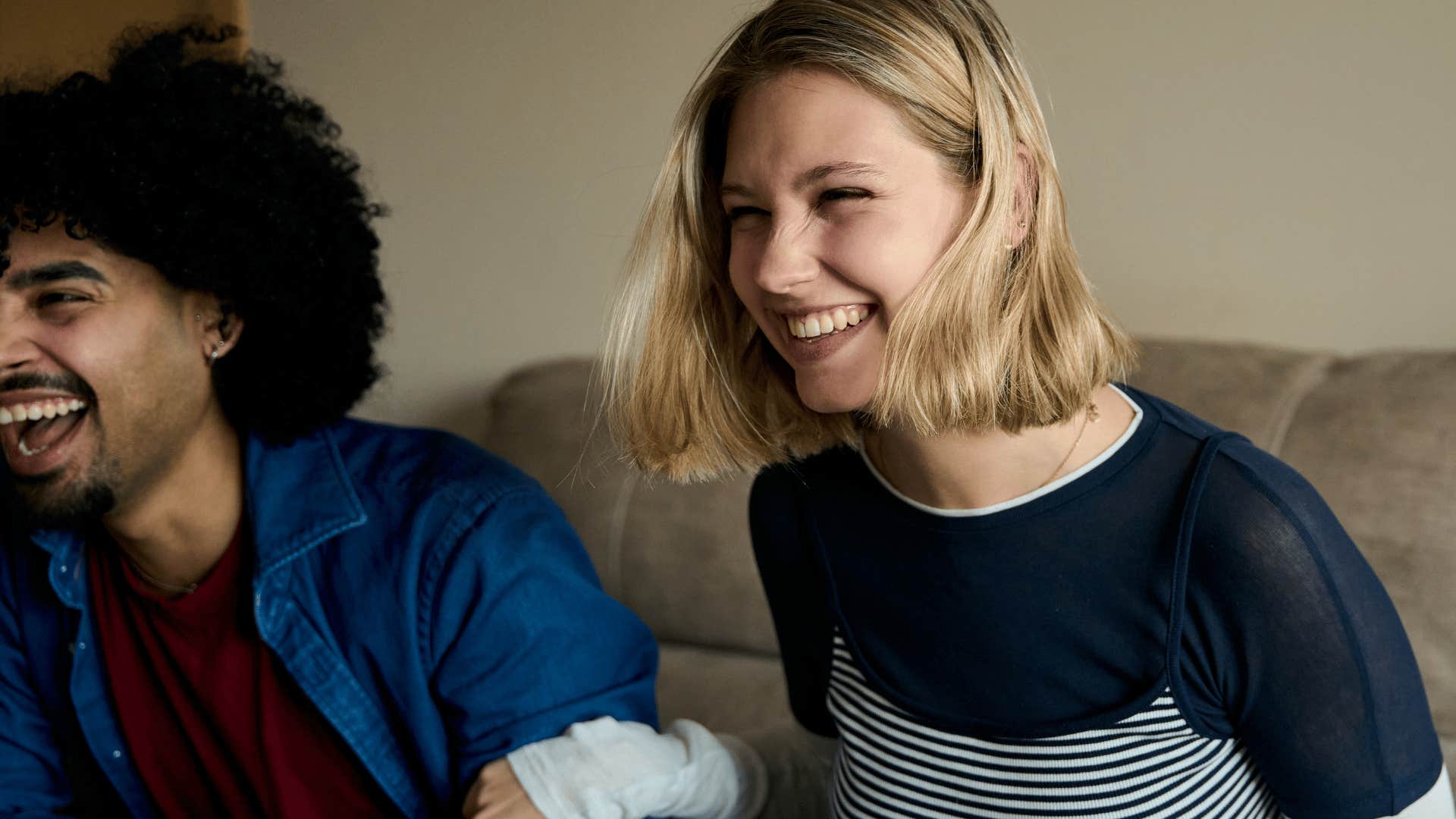 woman noticing her partner's humor and laughing with him