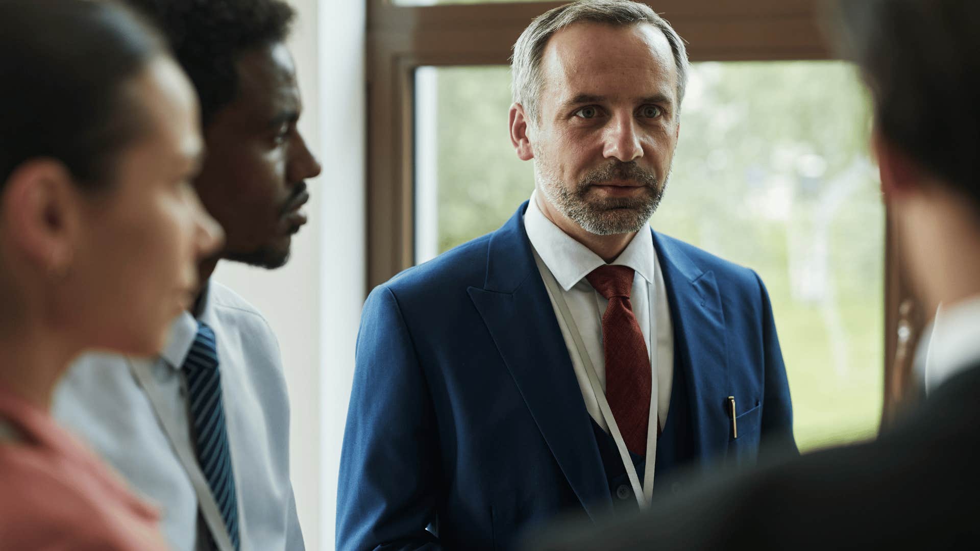 businessman noticing a co-worker's need for attention in meeting
