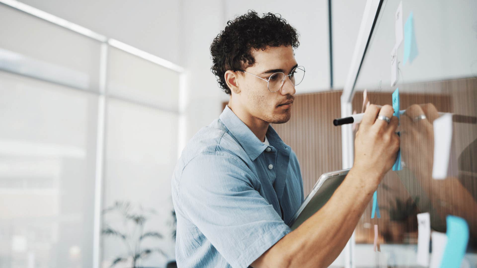 man with ADHD hyperfocusing on random things as he writes on board