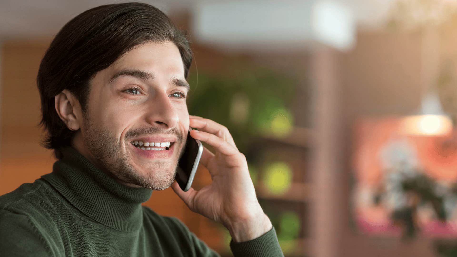 man with ADHD on phone smiling as he talks too much