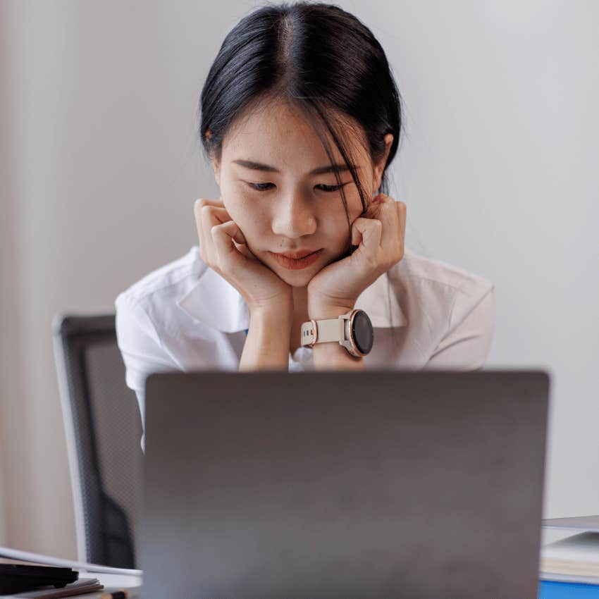 shy woman writing an email to colleague that says no worries if not