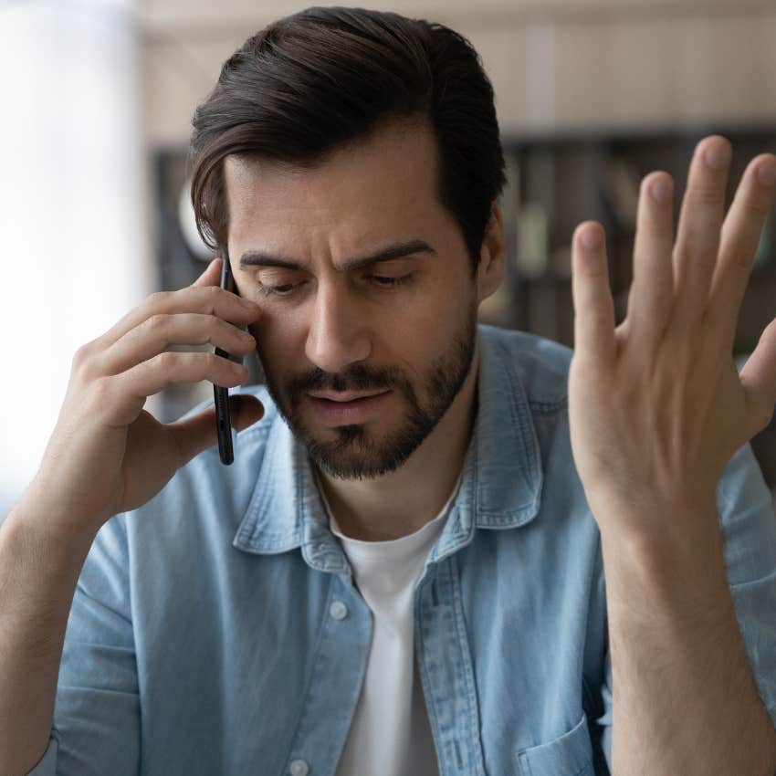 man frustrated on the phone having to repeat himself