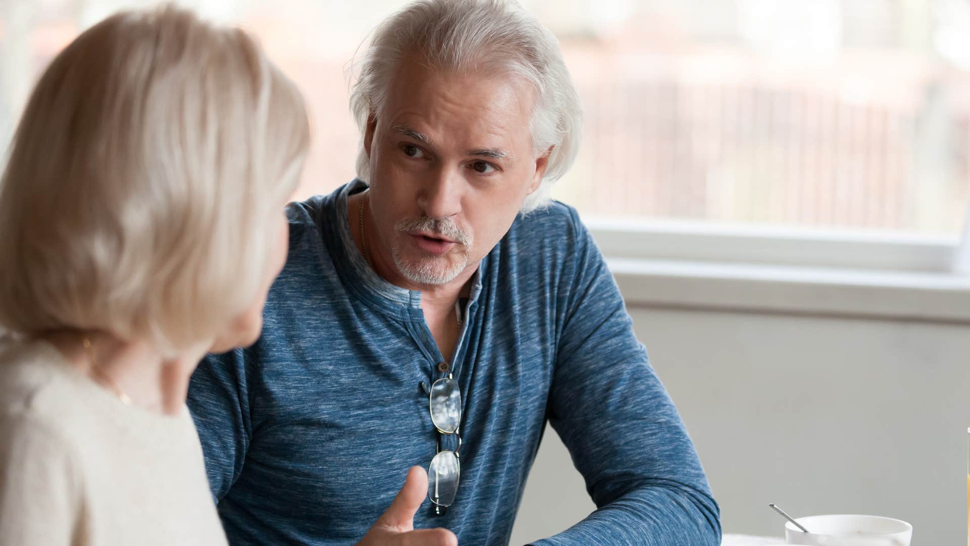 man calling out guest in his home for sitting in someone's seat