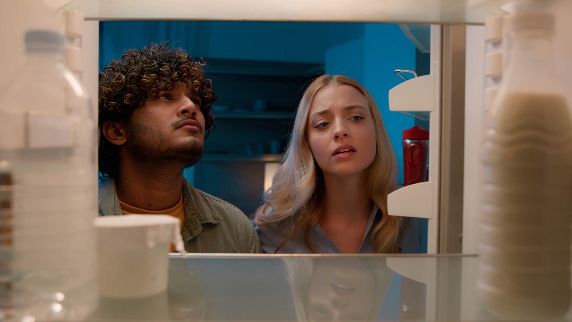 guests searching fridge for something to eat and drink