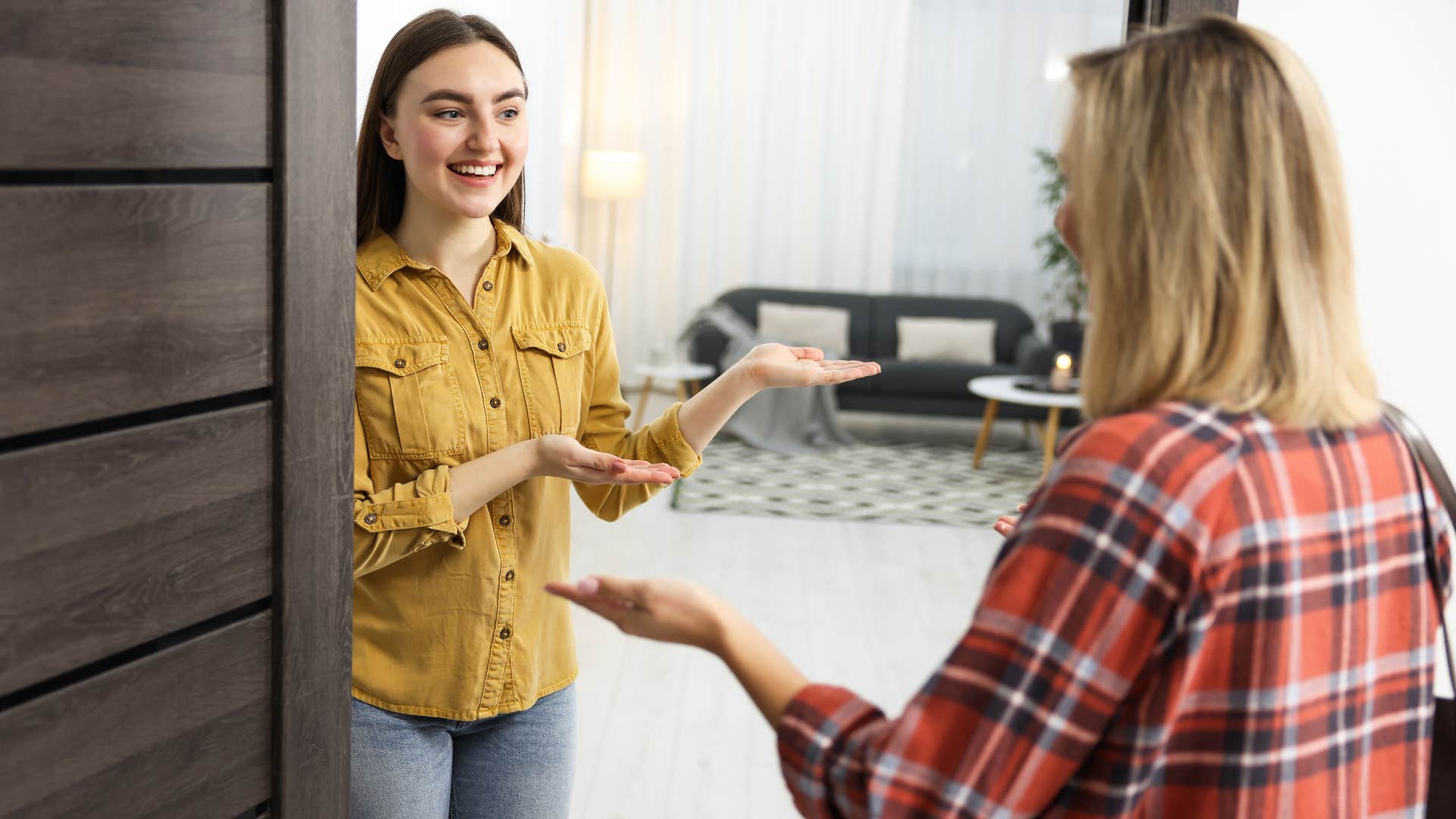 woman entering friend's home not sure where to put her things