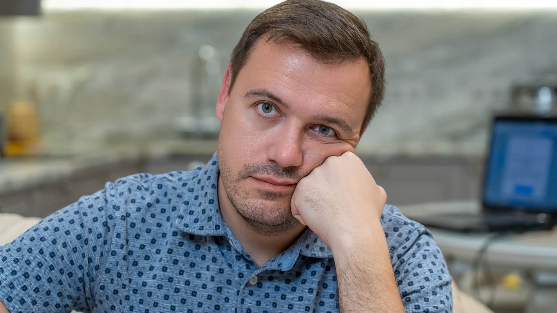 man being a guest in someone's home confused at where to sit
