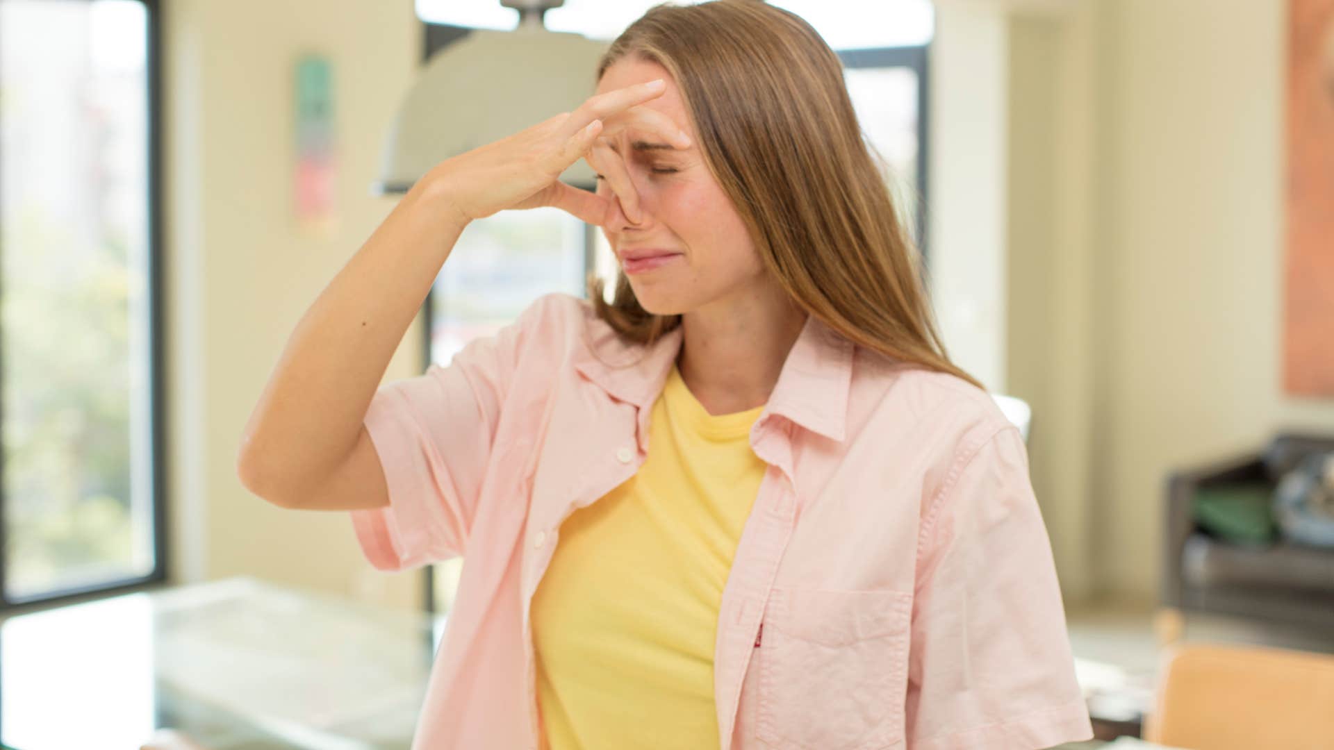 woman who's a guest in someone's home smelling something gross
