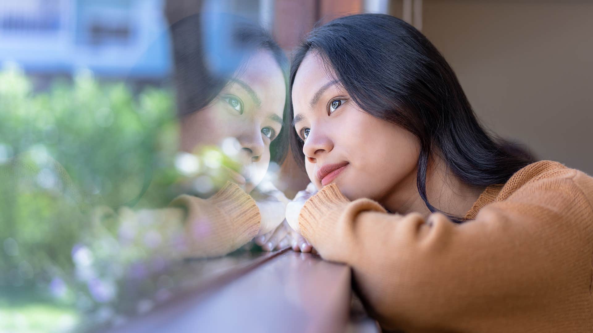 smart woman daydreaming looking out a window