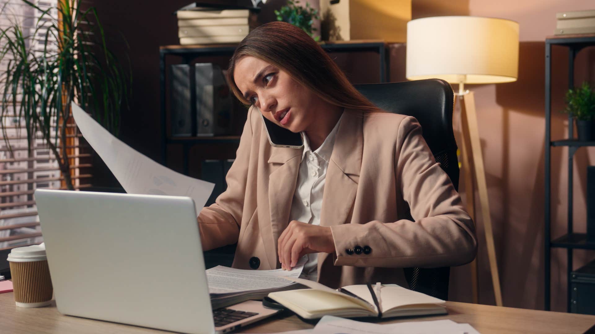 truly smart woman busy at work keeping her desk busy intentionally