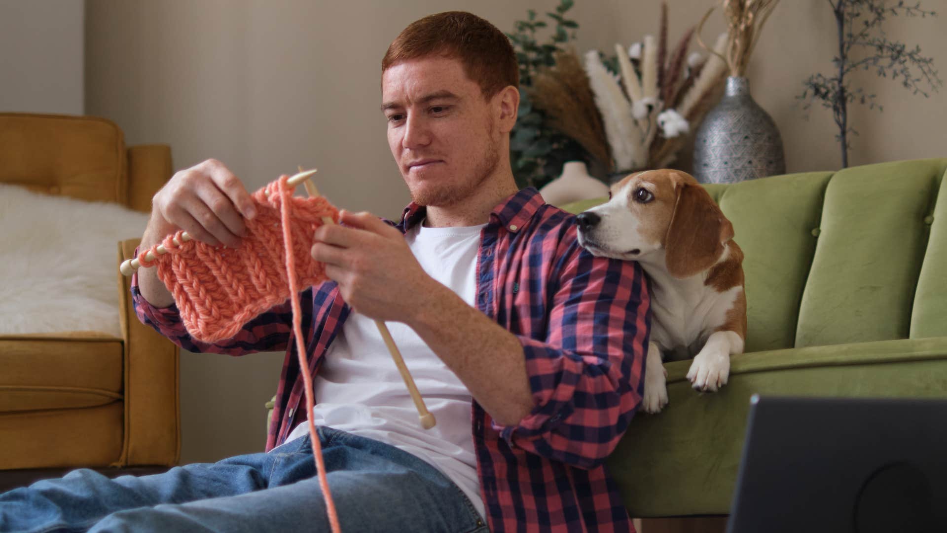 intelligent man knitting at home choosing analog hobbies over ditigal ones