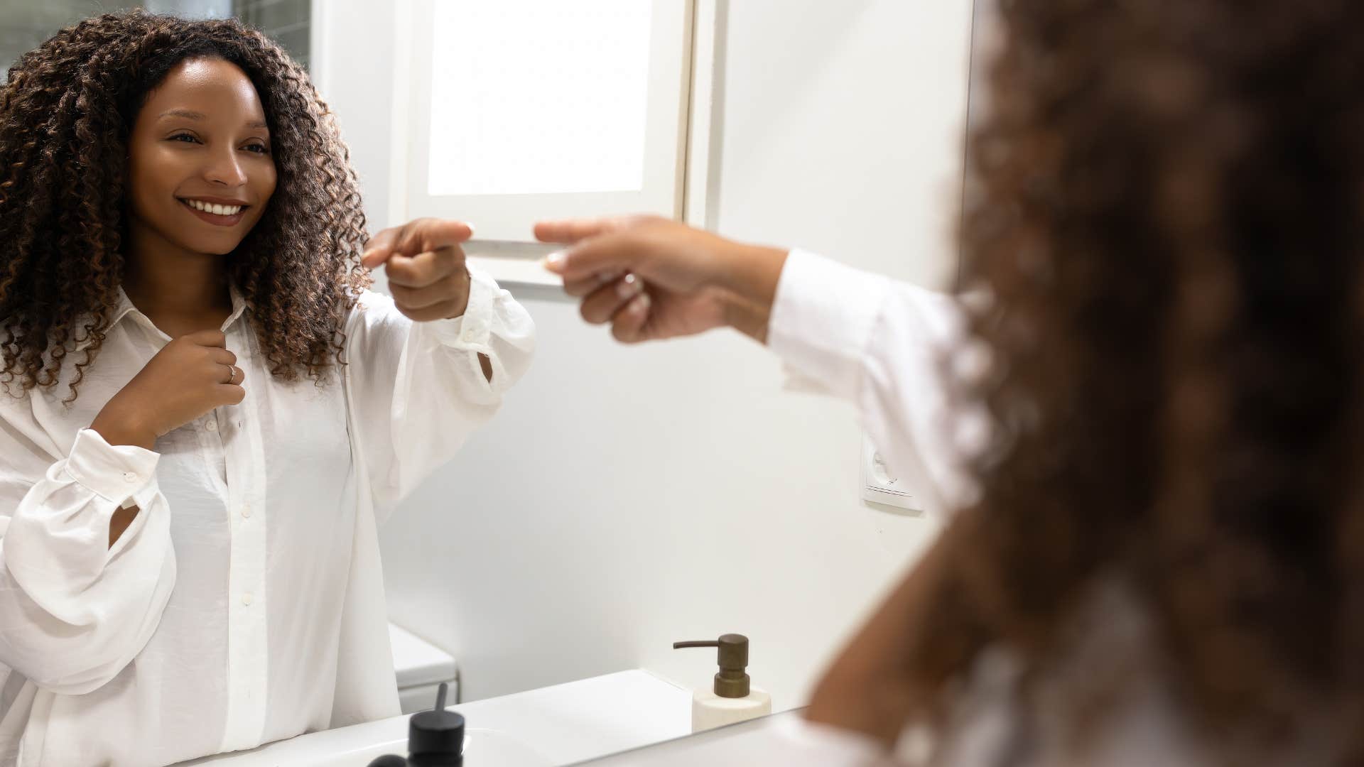 happy and intelligent woman looking in the mirror talking to herself