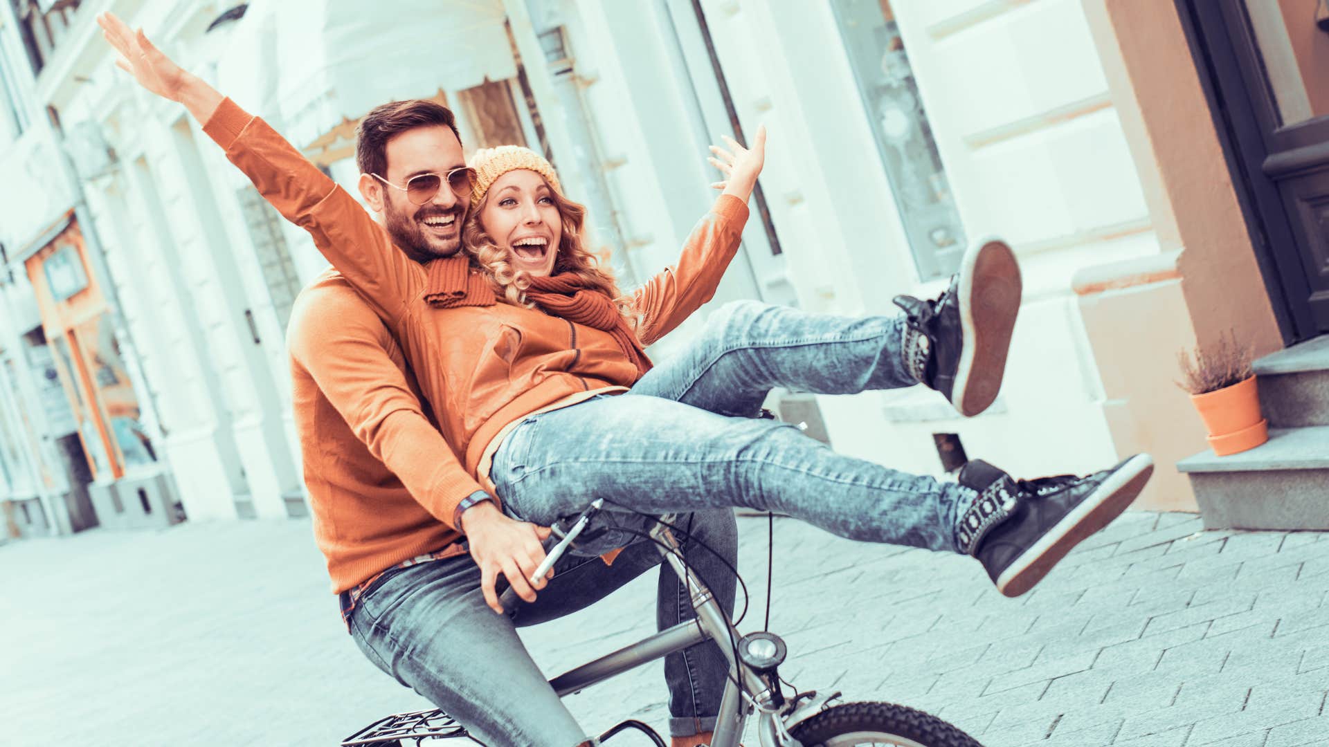 intelligent couple trying new things riding bike together
