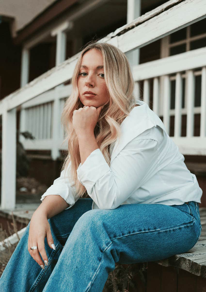thoughtful woman sitting outdoors