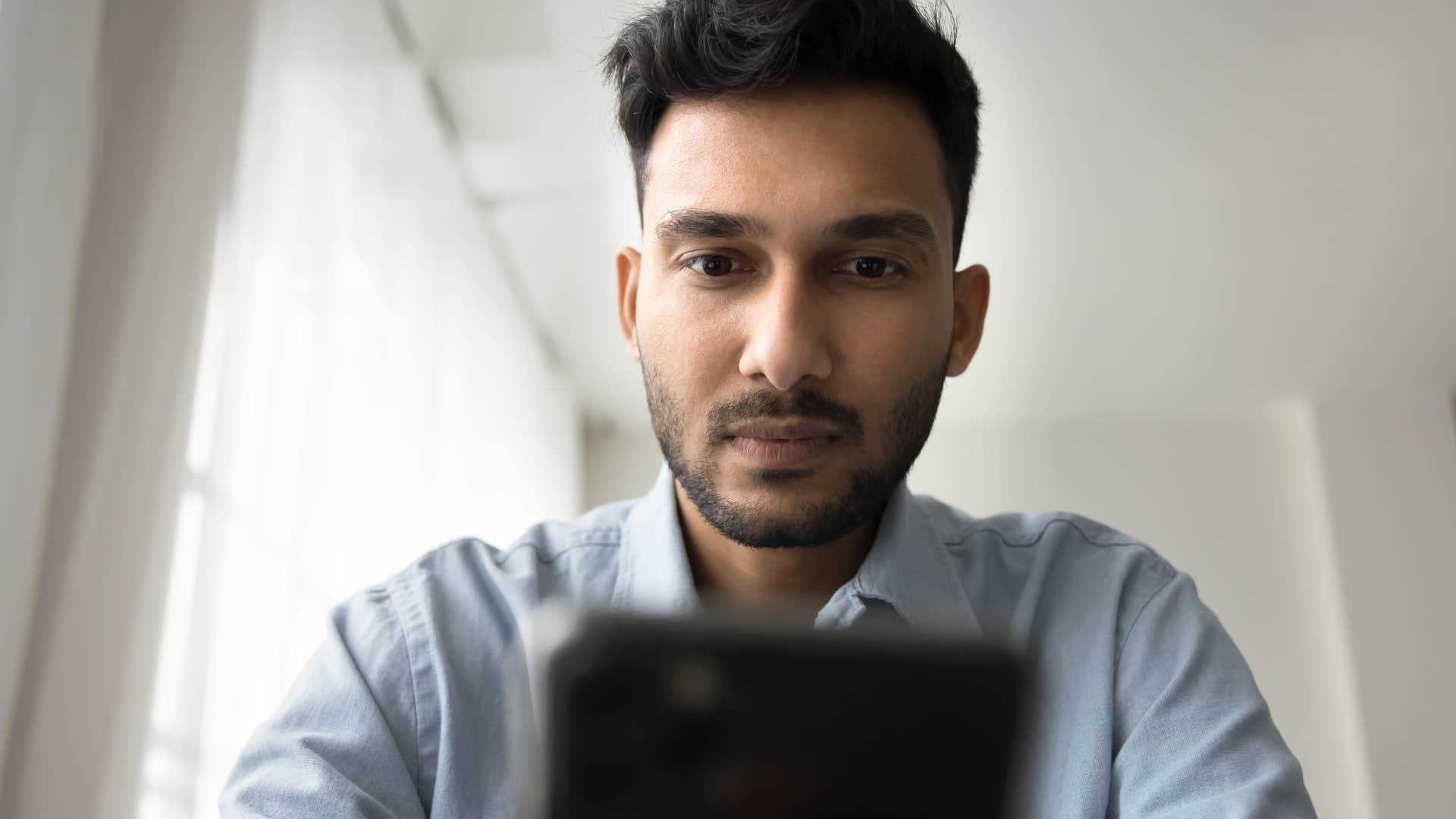 man with zero common sense dependent on his phone