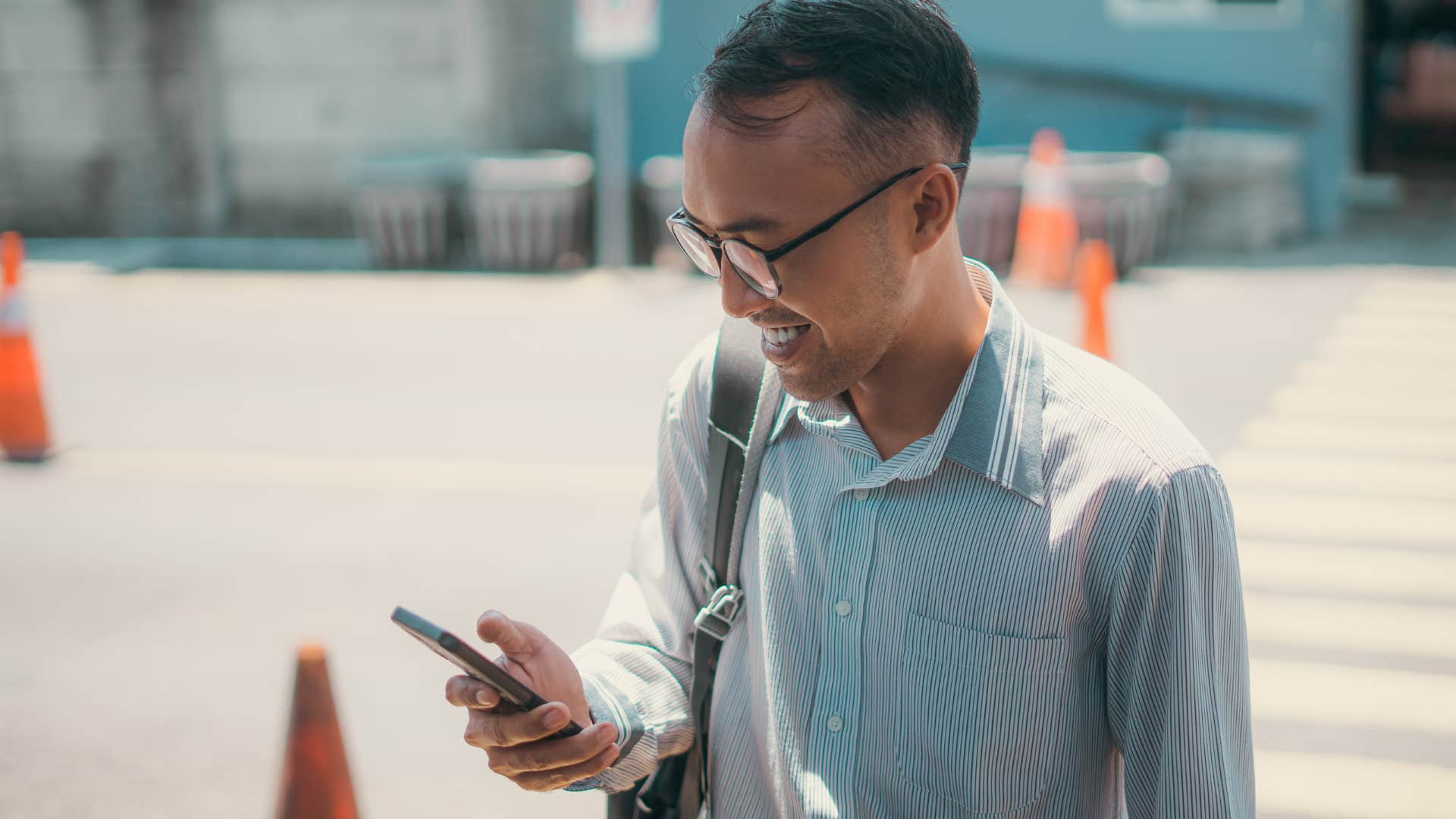 man lacking social awareness walking with his phone