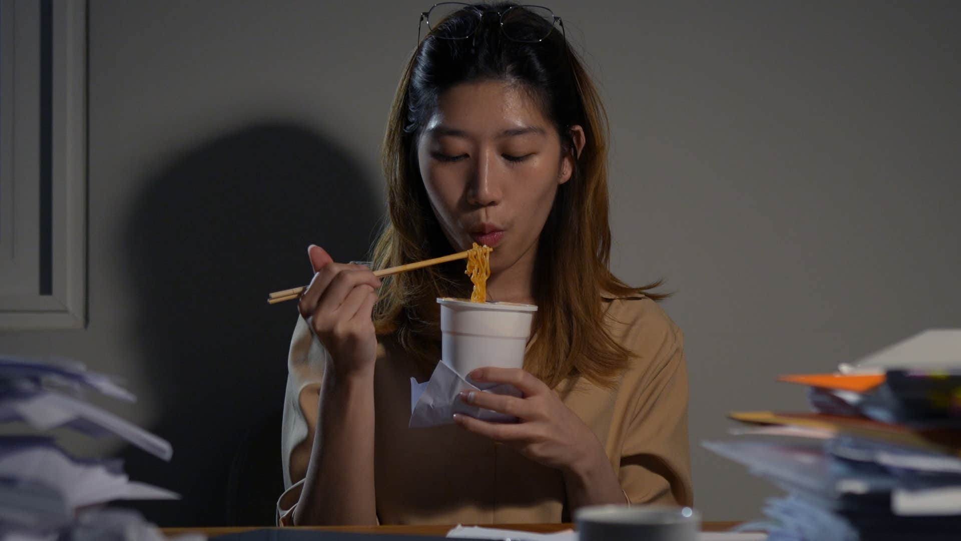 woman eating lunch alone at work in an office