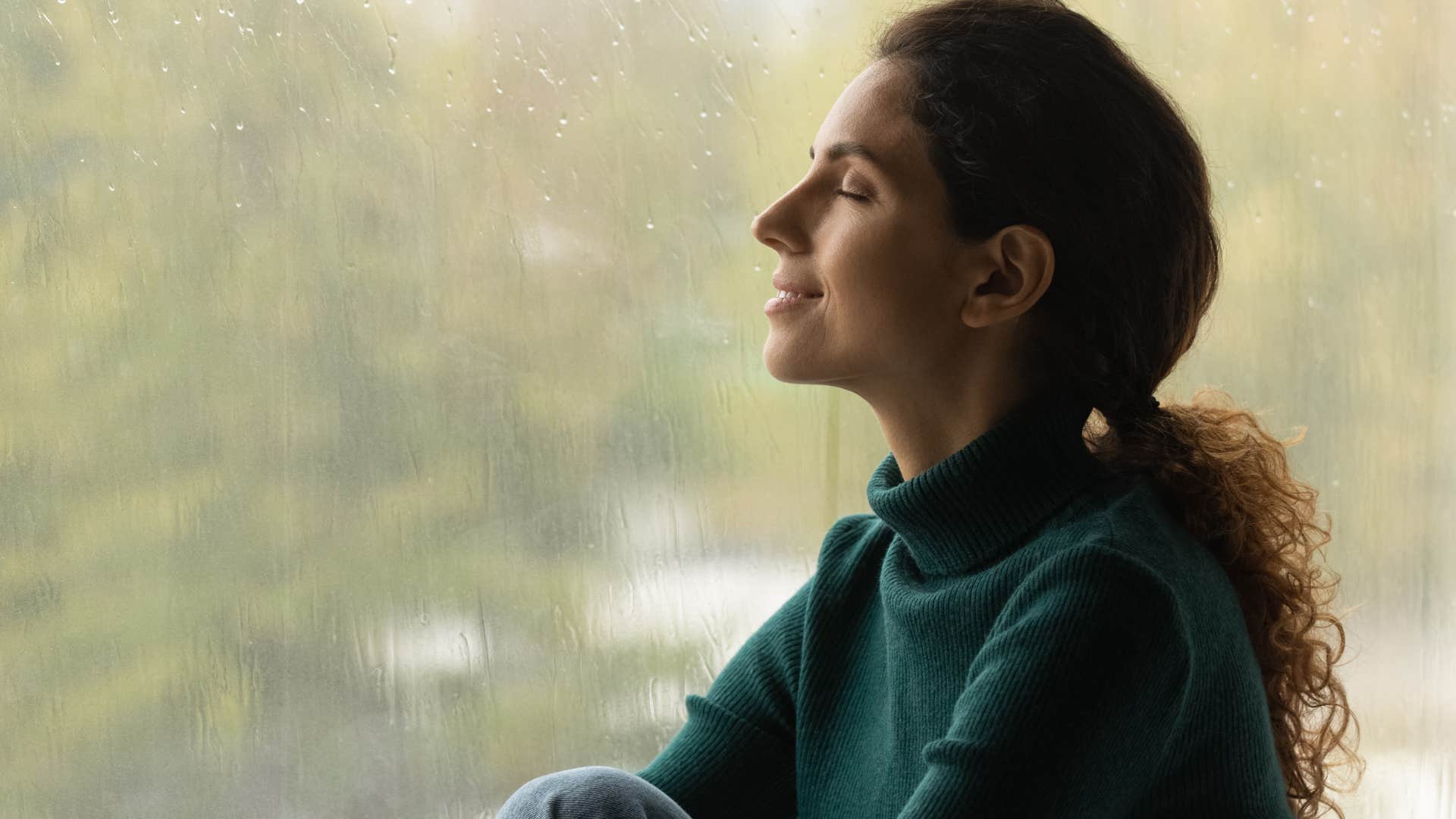 introverted woman smiling watching thunderstorms