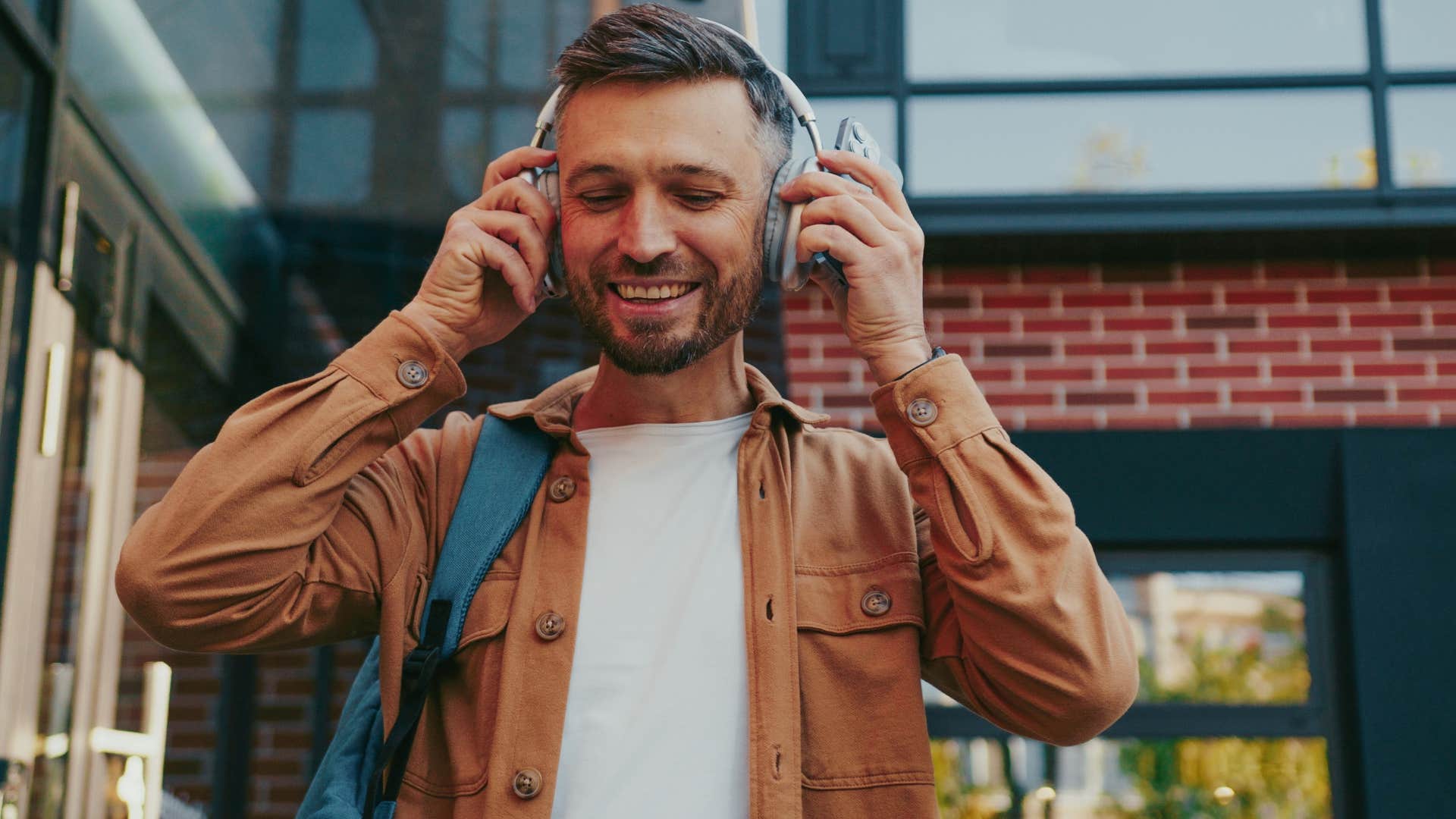 man running errands alone with headphones on