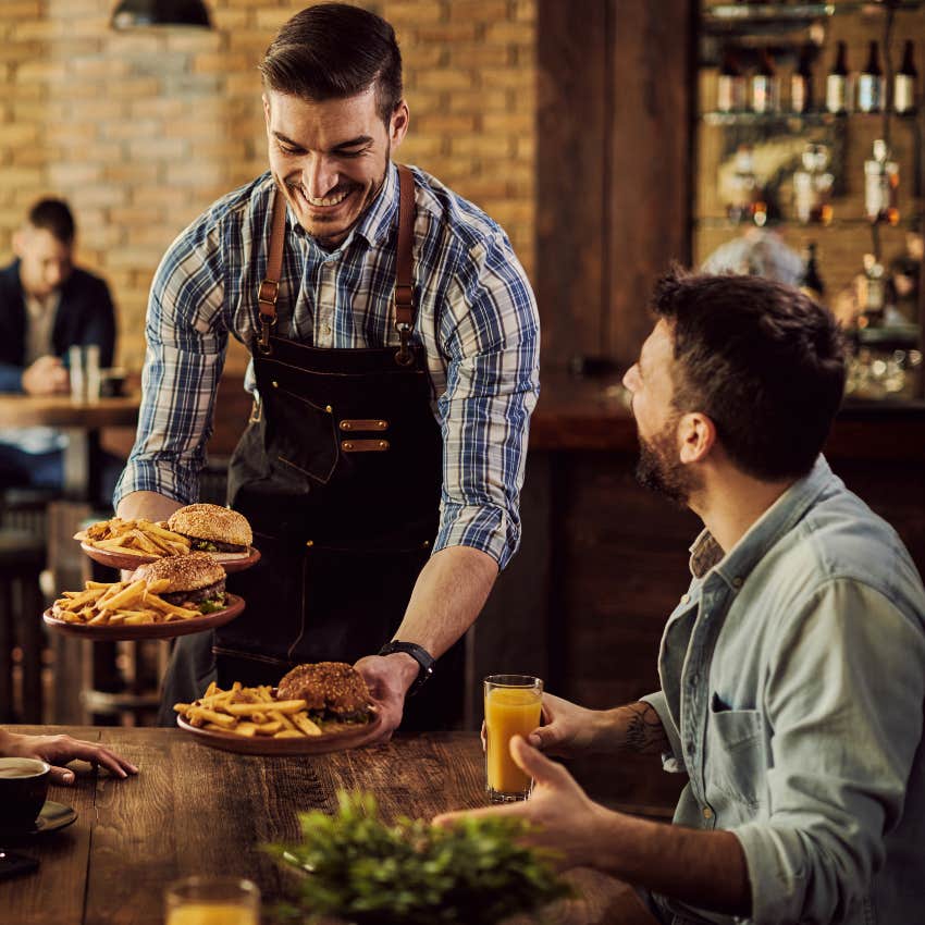 male waiter bringing food to table at restaurant has valuable skills for any employer