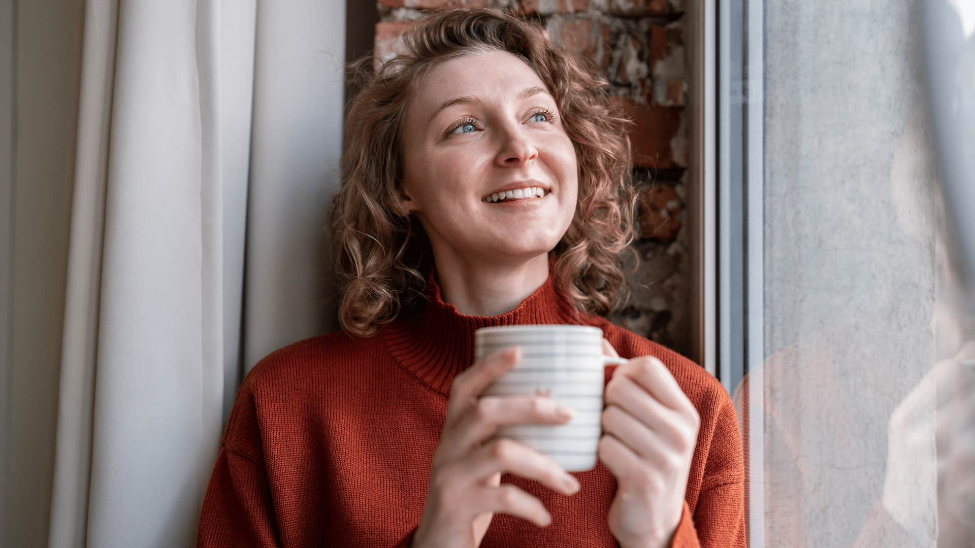 peaceful happy woman carving out time for stillness at home