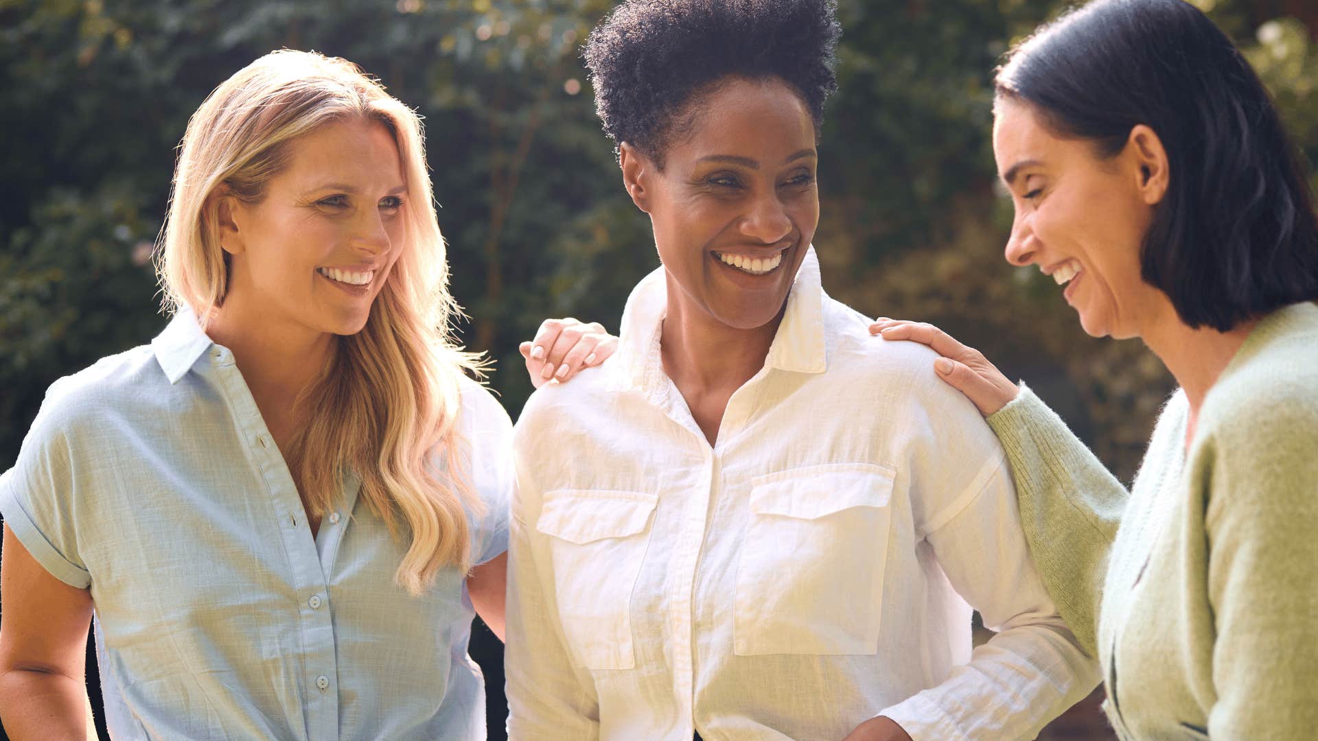 happy woman surrounding herself with small circle of friends
