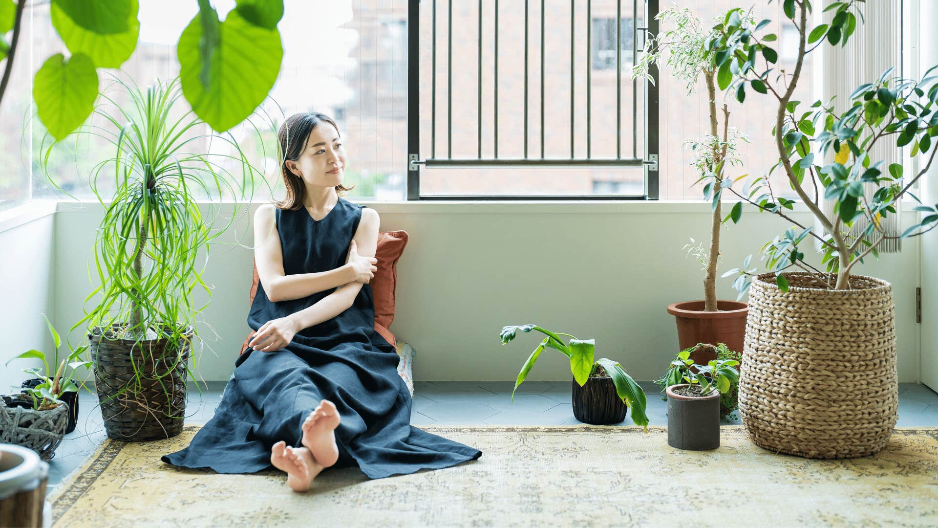 happy woman protecting her peace sitting in her sacred space at home