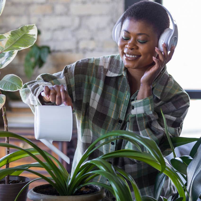 woman manifesting income by intentionally taking care of plants