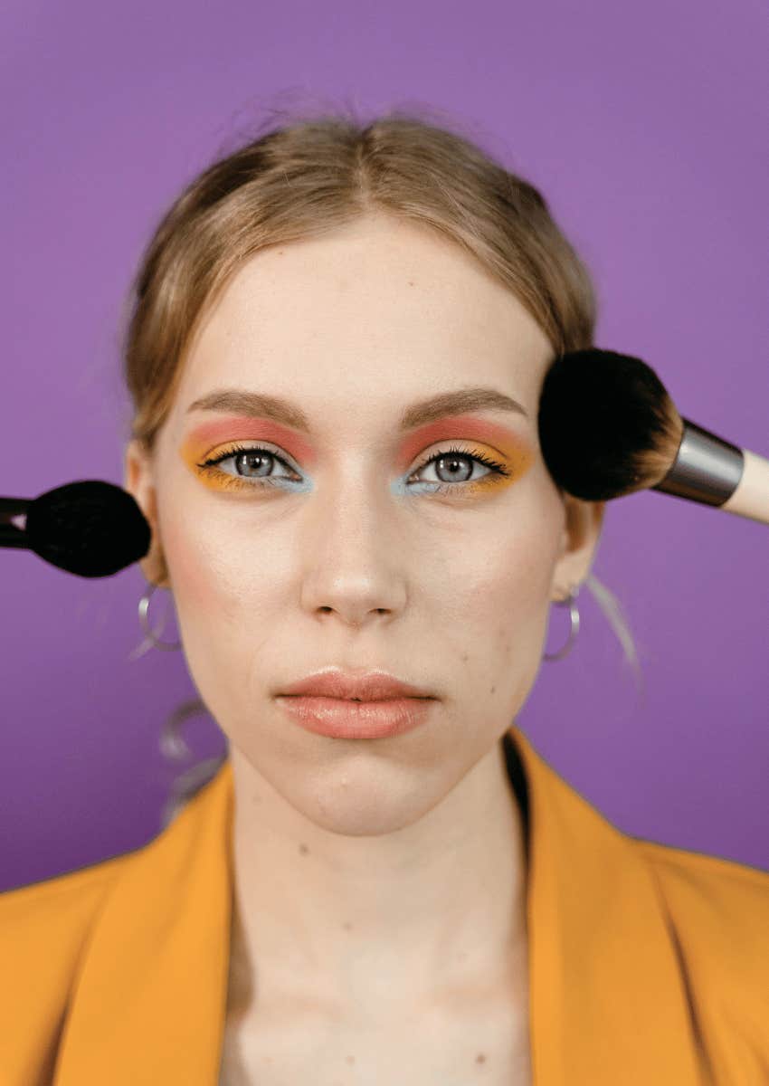 woman in blazer wearing bright makeup