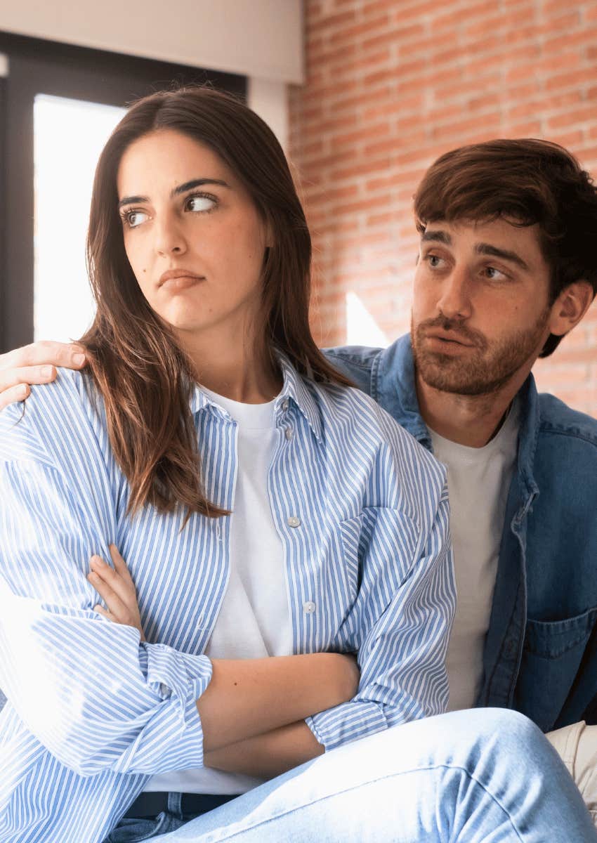 woman looking away from man who is apologizing