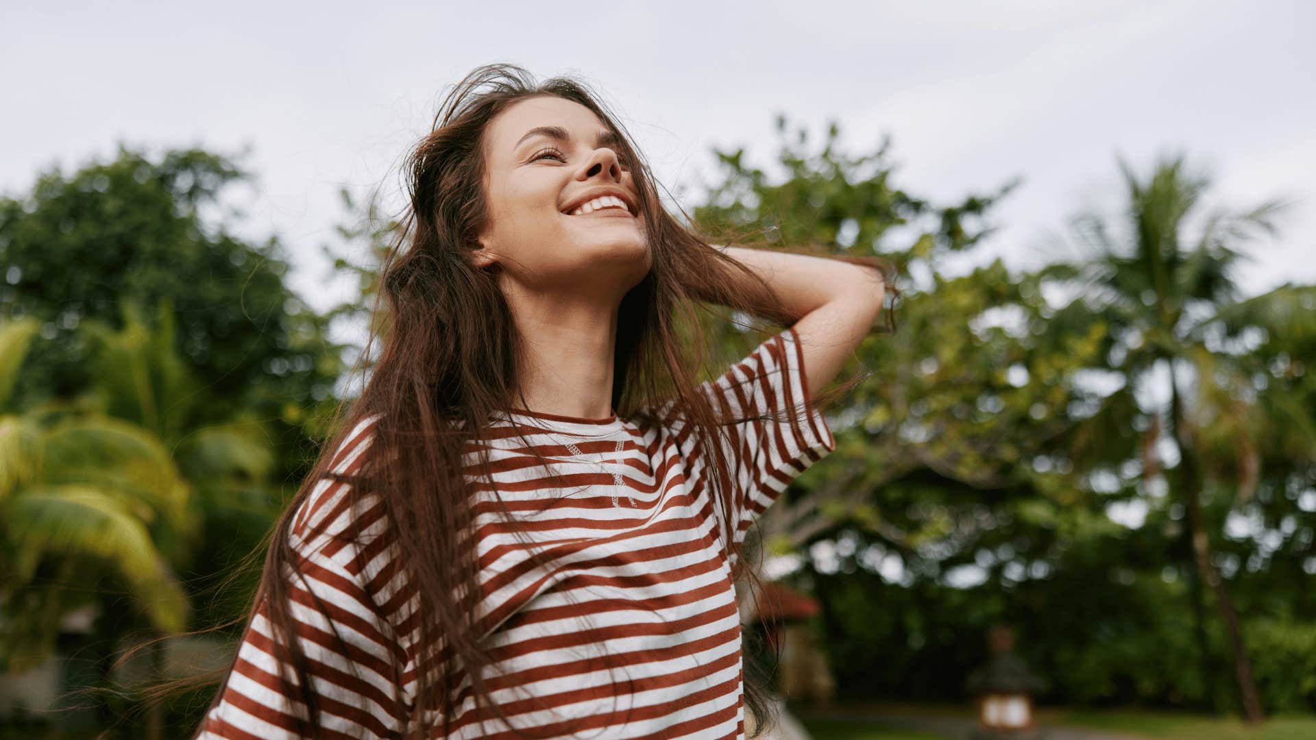 woman who is an old soul smiling at sky