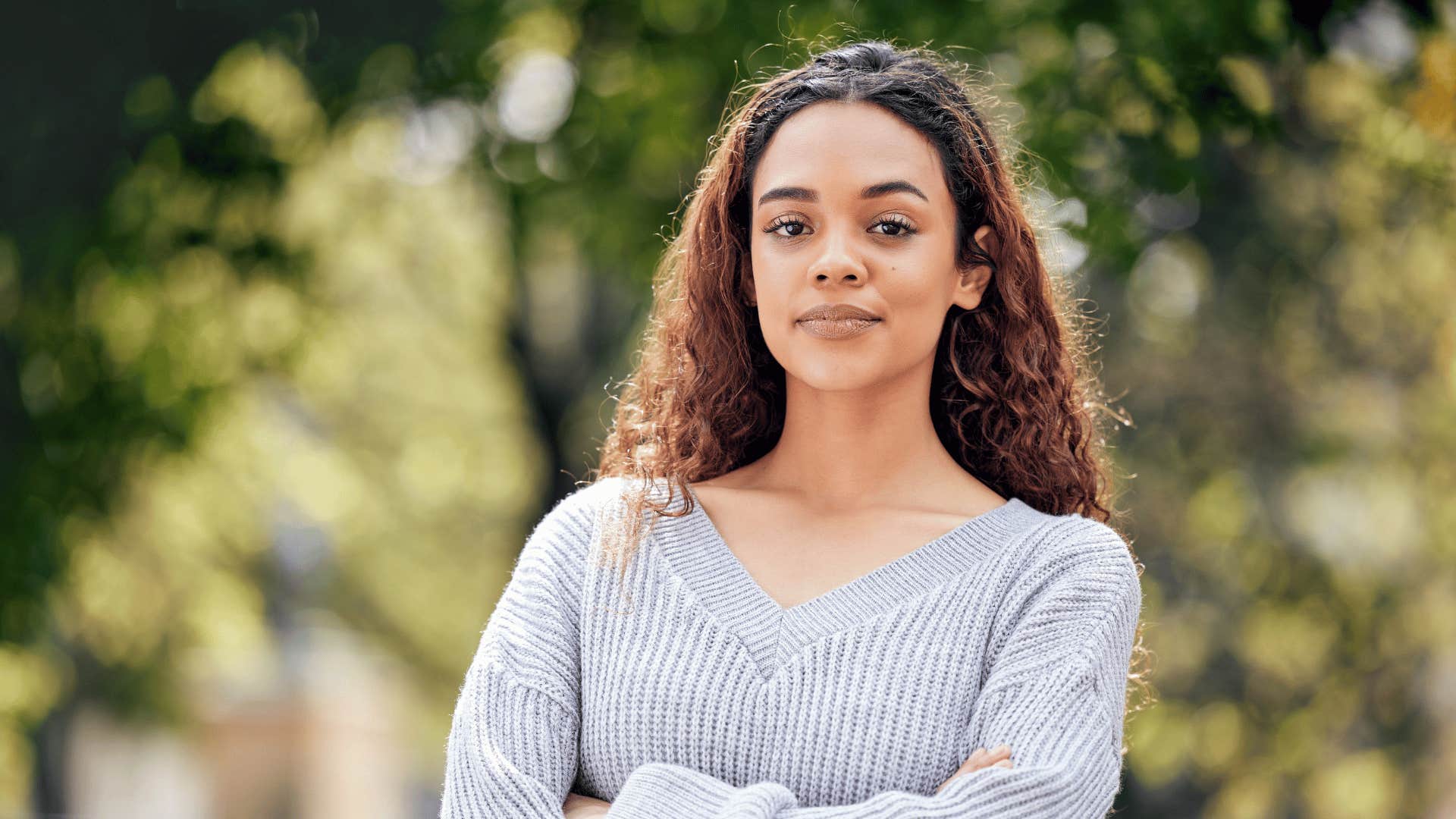serious woman with her arms crossed looking intimidating