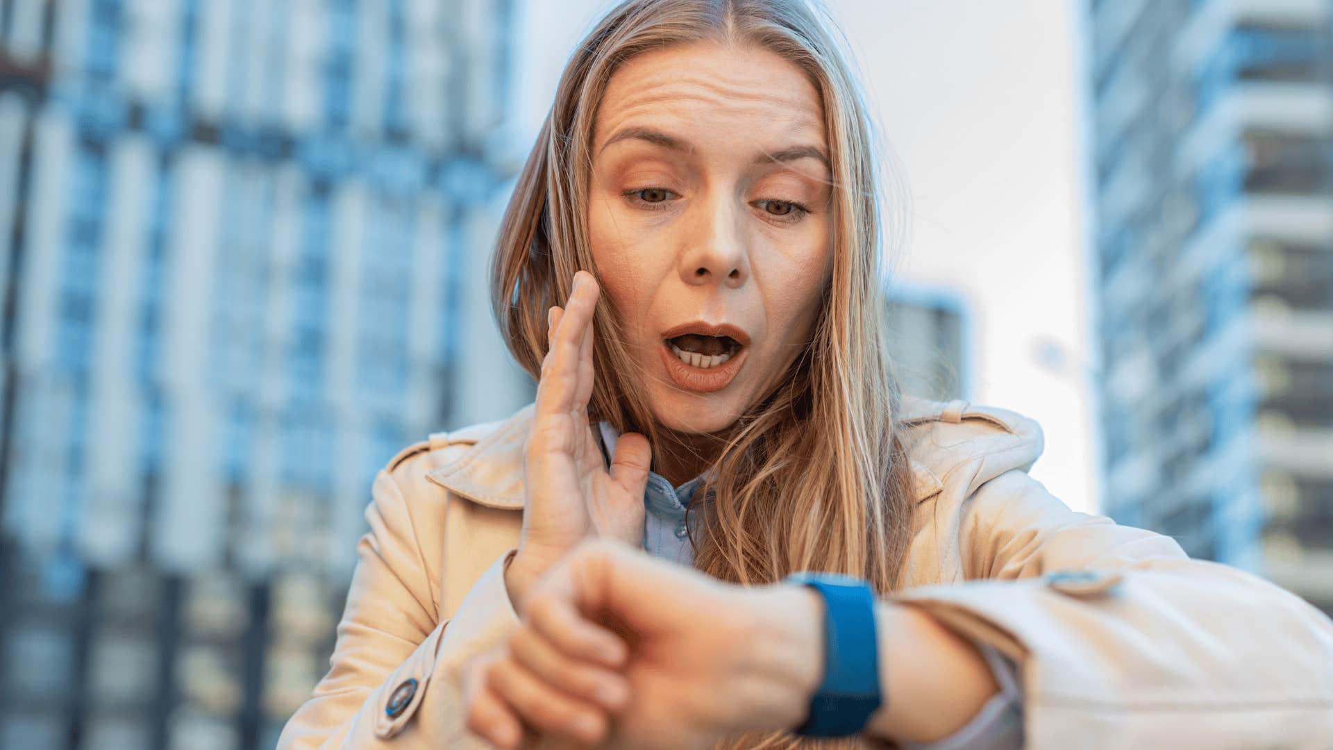 Woman looking at her watch and saying "I'm late!"