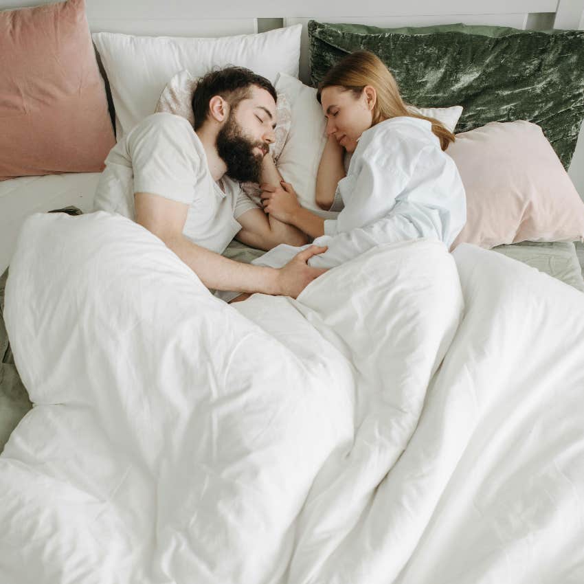 happy couple sleeping close together