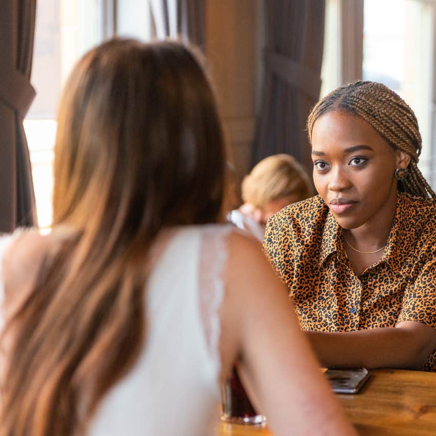 intelligent woman being curious while listening to her friend
