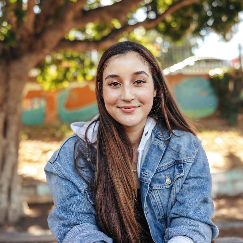 woman smiling while sitting outside