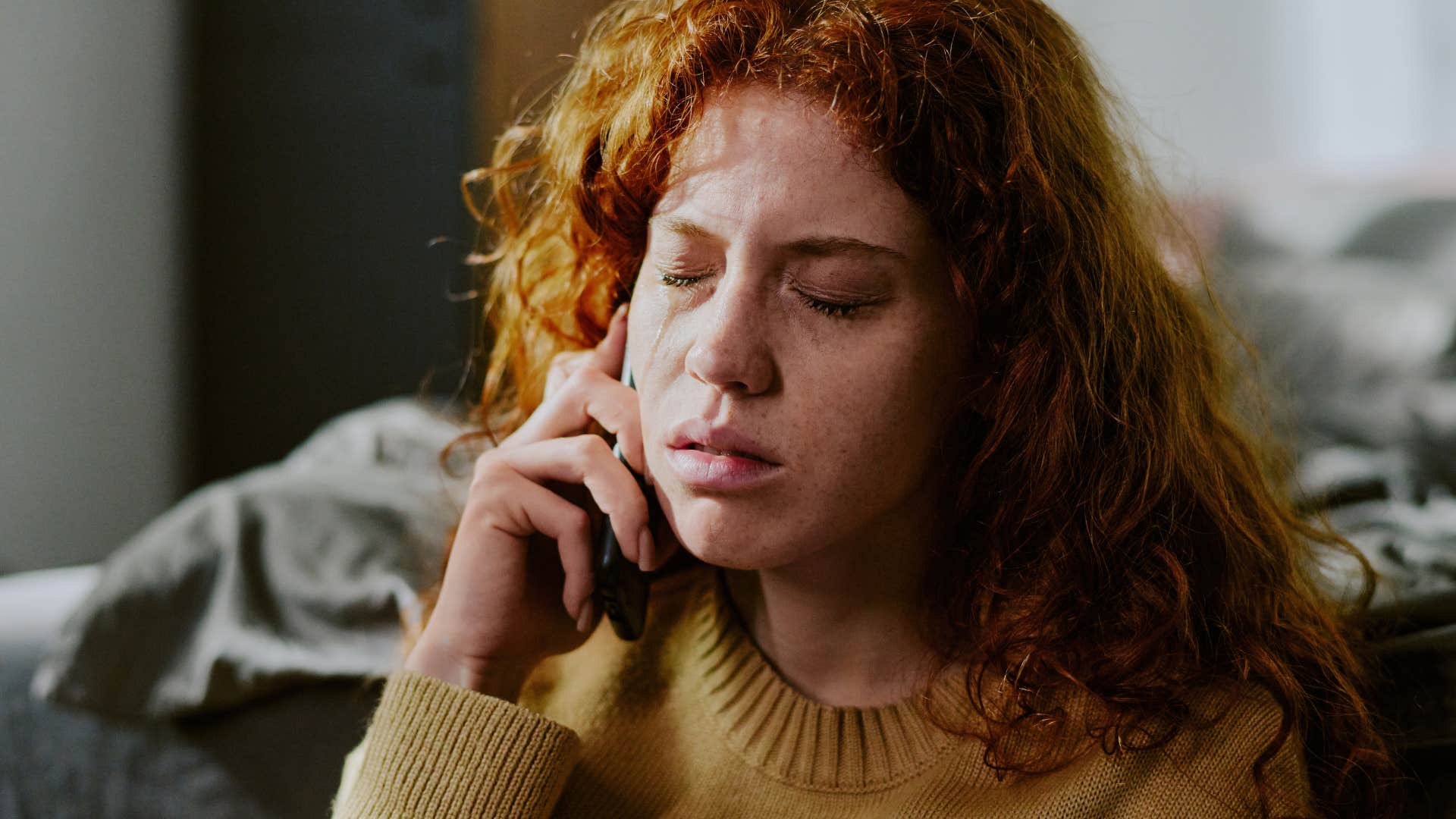sad woman on the phone telling friend I knew this would happen