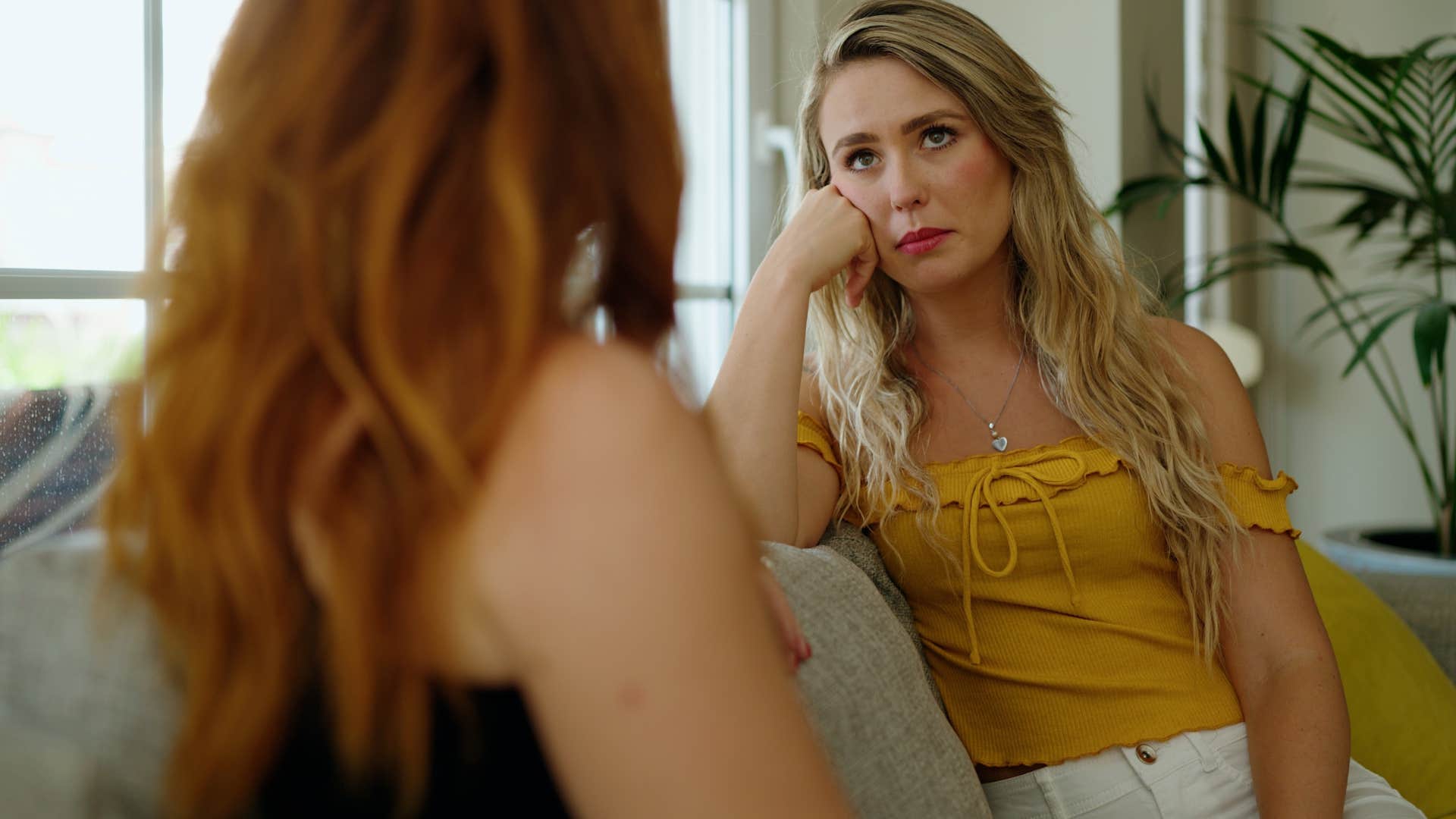 woman talking to very sad friend who's asking what's the point