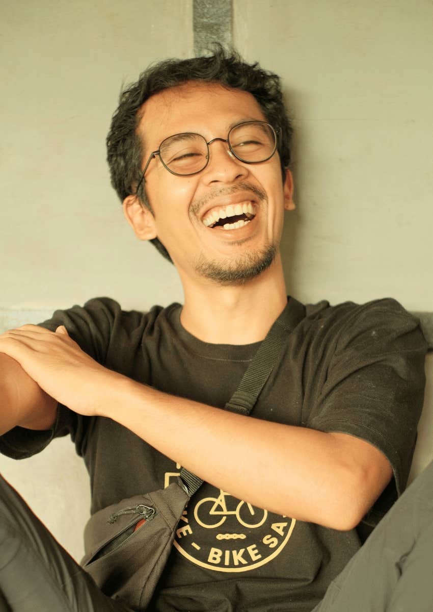young man smiling big not blaming others for problems