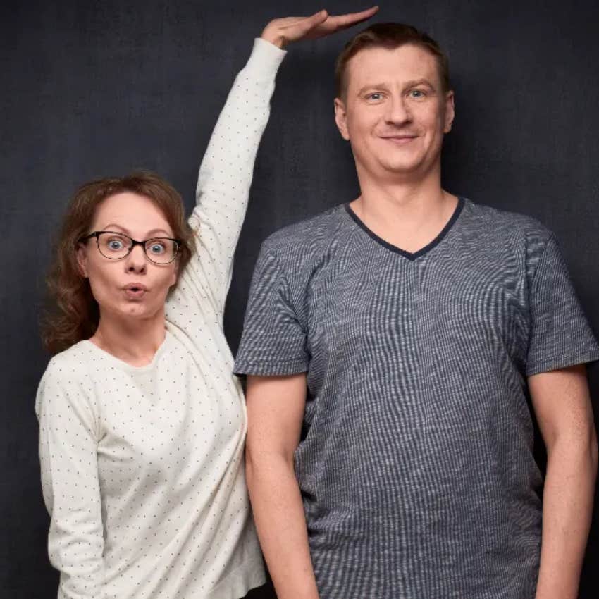 woman pointing out how tall a man is