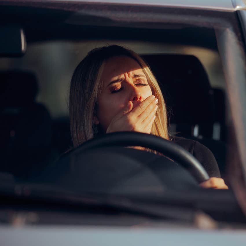 woman yawning while driving car