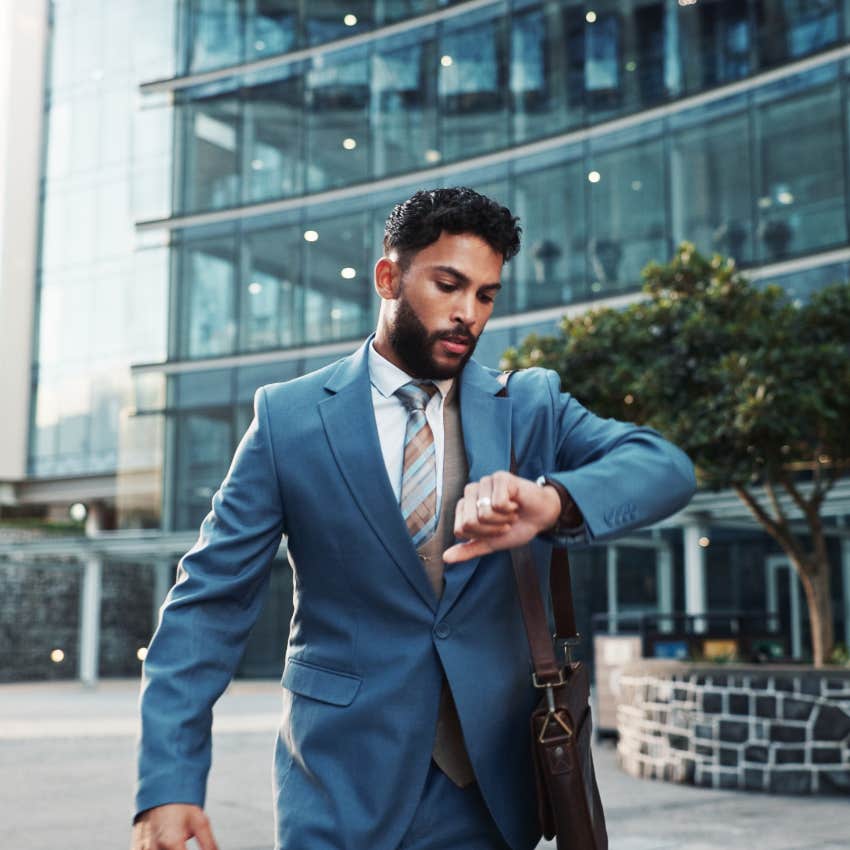 businessman checking his watch rushing to work