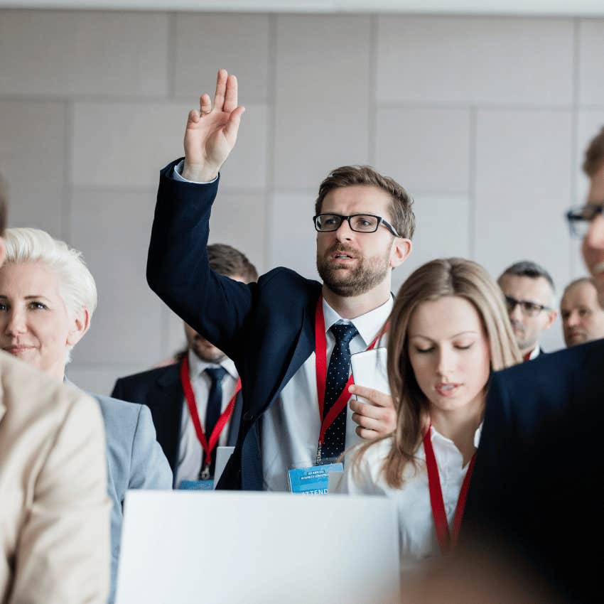 man revealing how smart he is by asking questions at a meeting