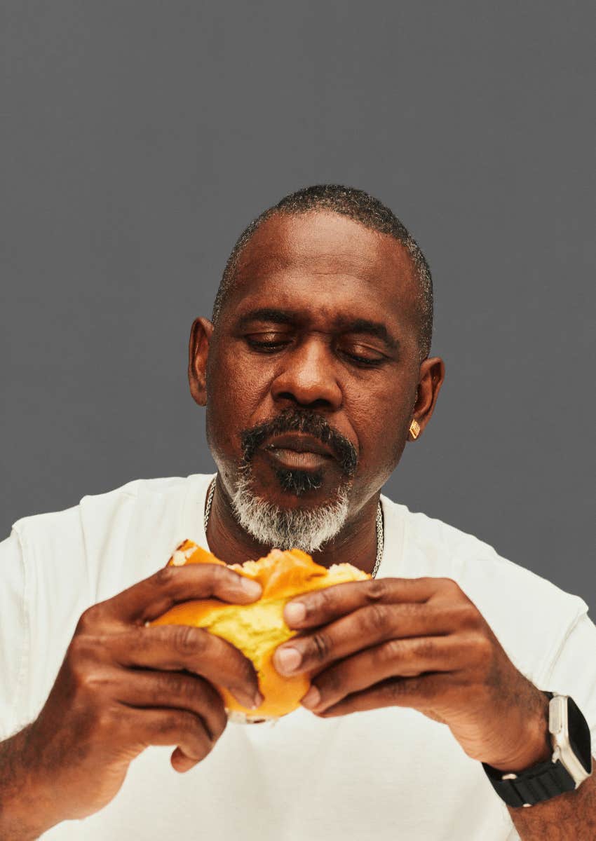 boomer man eating a hamburger