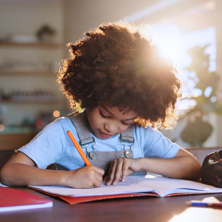 elementary school girl writing and addressing letters